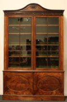 A 19th century Adam Revival mahogany library bookcase, arched cresting carved and applied with a