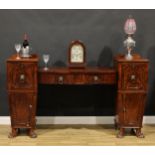 A Regency mahogany twin pedestal sideboard, possibly Scottish and of small proportions, lion mask
