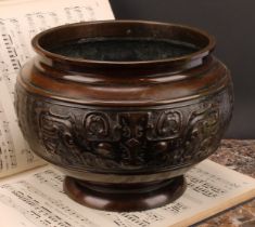 A Chinese patinated bronze ovoid pedestal jardiniere, relief decorated in the Archaic taste, 21cm