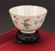 An 19th century Chinese fluted circular bowl, painted in the famille verte palette with flowers