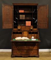 A George III oak estate office enclosed bureau bookcase, moulded cornice above a pair of raised