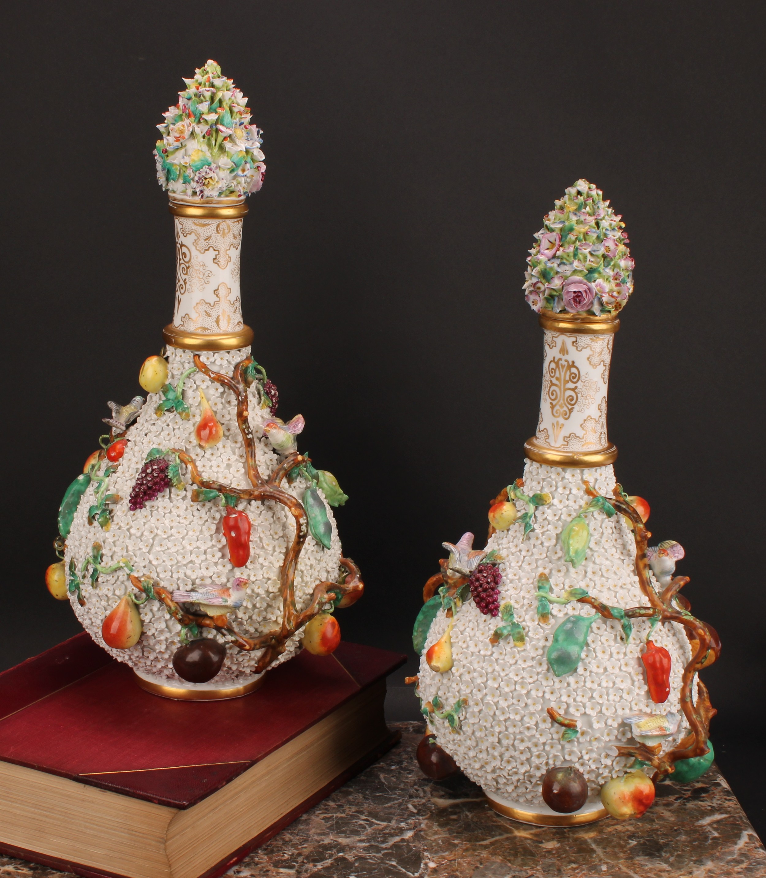 A pair of Meissen schneeballen bottle vases and covers, typically encrusted and applied with birds