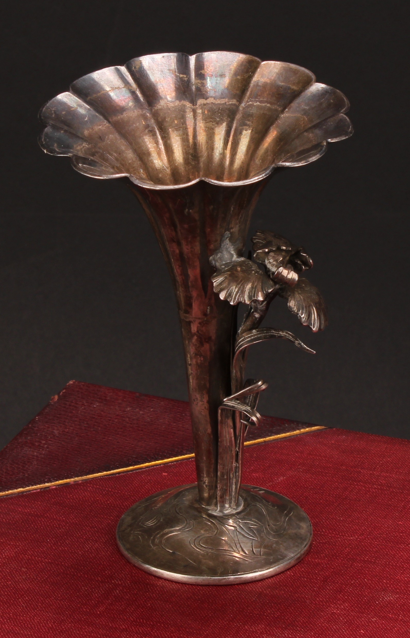 A Japanese silver fluted trumpet shaped posy vase, applied with a flower, 11.5cm high, character