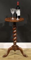 A 19th century laburnum and walnut candle stand, oyster-veneered octagonal top, spirally turned