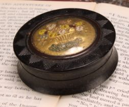 An early 19th century pressed horn waisted circular snuff box, the push-fitting cover decorated in
