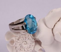 A sky blue topaz and 18ct white gold ring, the single large oval facet cut stone claw set, 16mm x