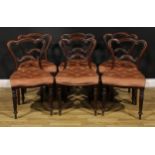 A set of six early Victorian solid rosewood dining chairs, cartouche shaped backs, stuffed-over