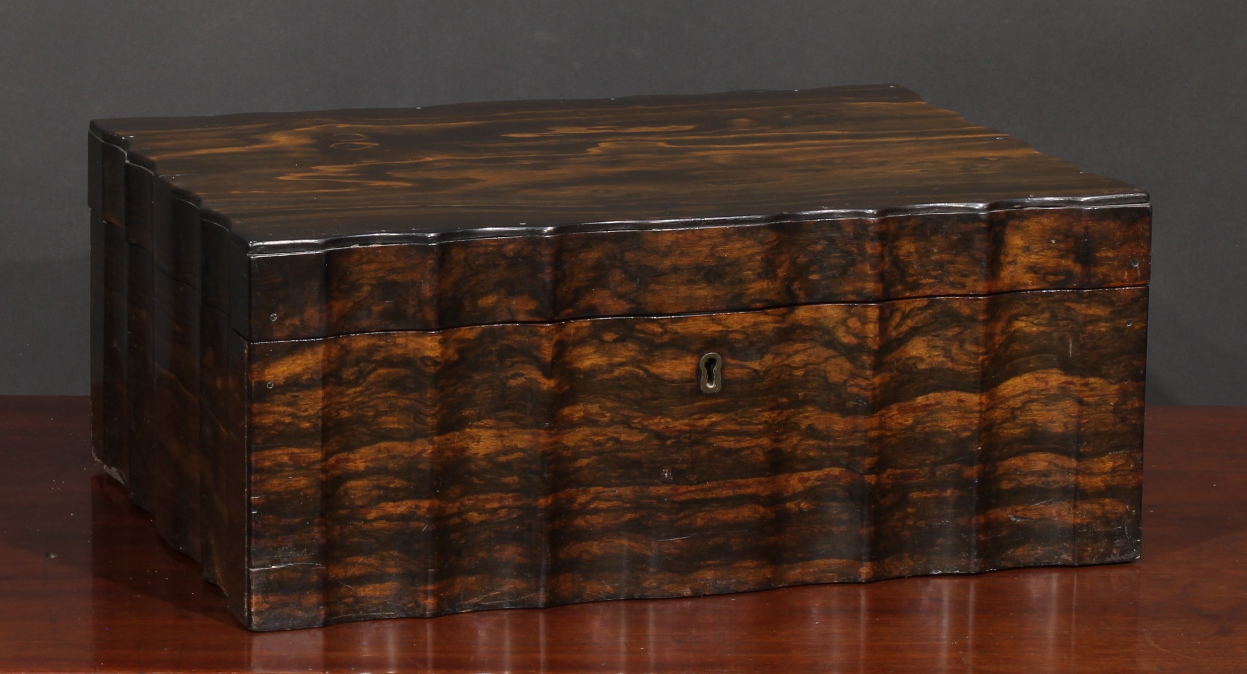 A 19th century Anglo Celanese serpentine sided shaped rectangular coromandel work box, the hinged