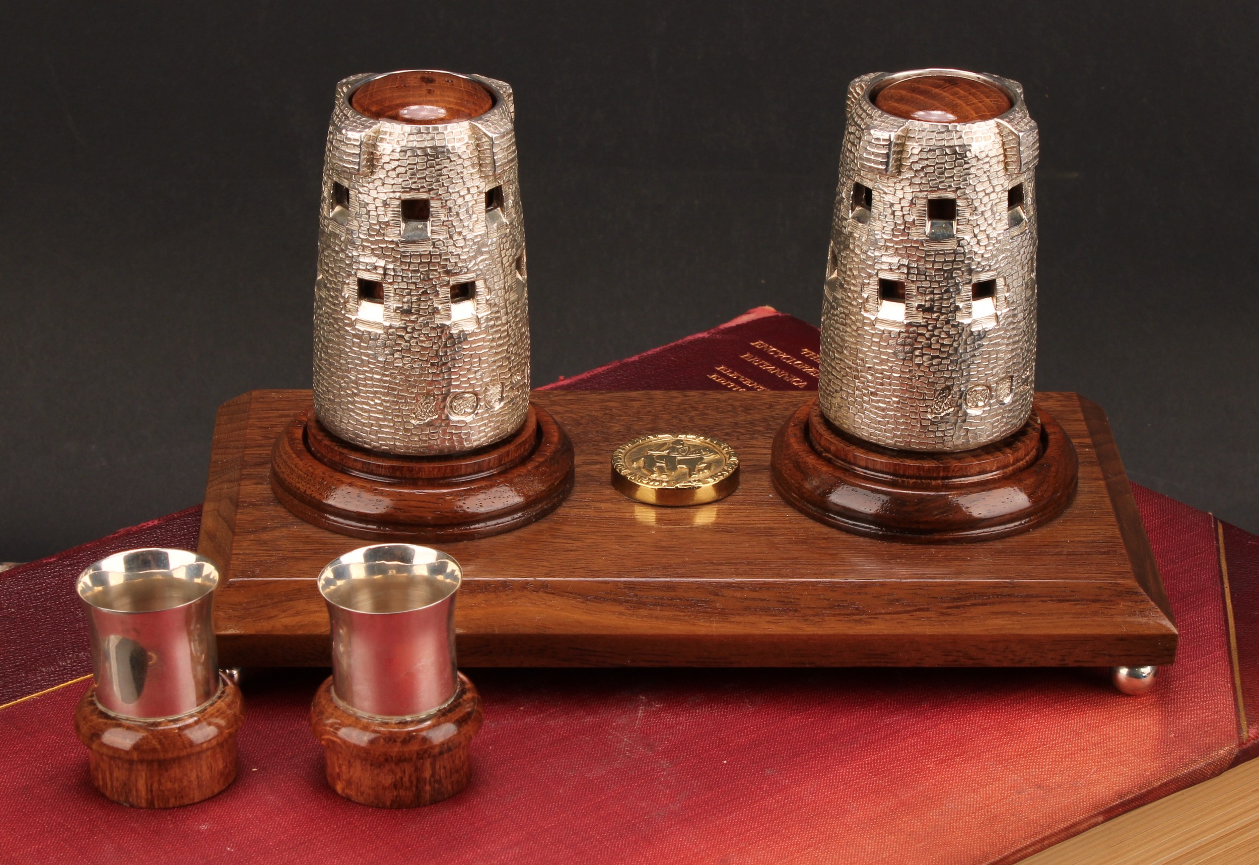 A Channel Islands silver novelty cruet stand, the condiments cast as Martello towers, each removable