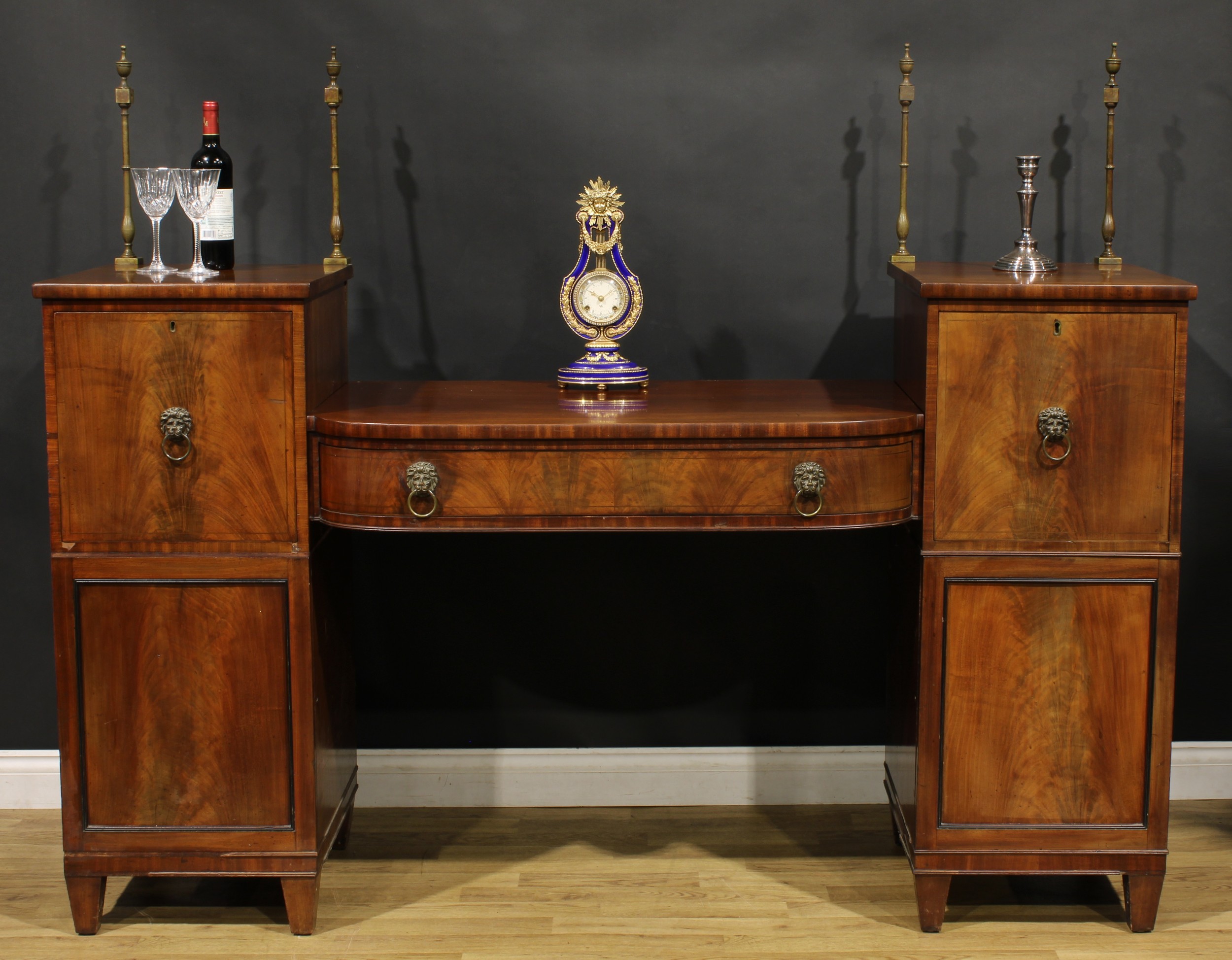 A Regency mahogany twin pedestal sideboard, sunken-centre with a long frieze drawer, flanked by deep