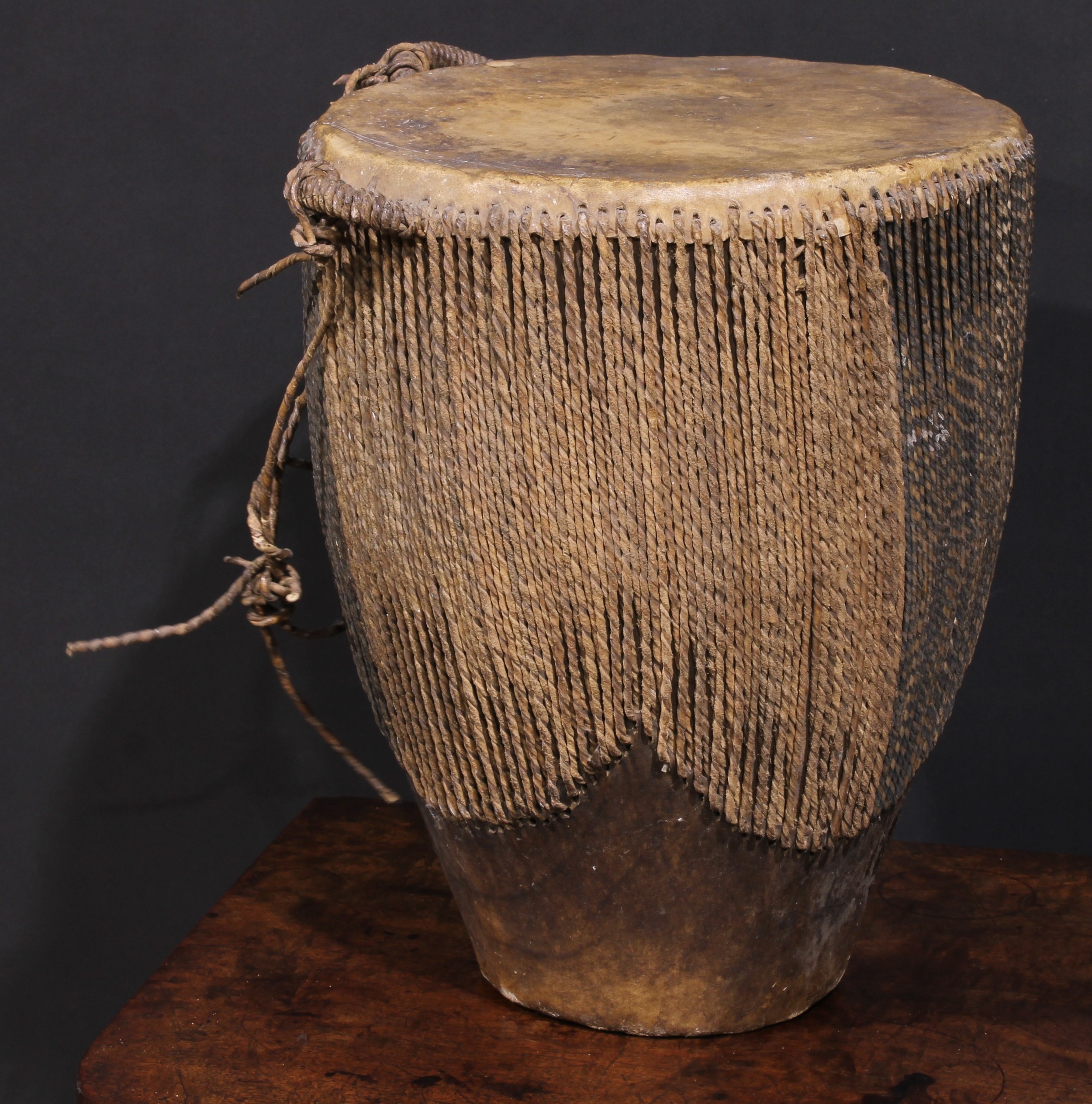 A Ugandan embuutu drum, hide bound hard wood, twin suspension loops, 39cm high, late 19th/early 20th - Image 2 of 3