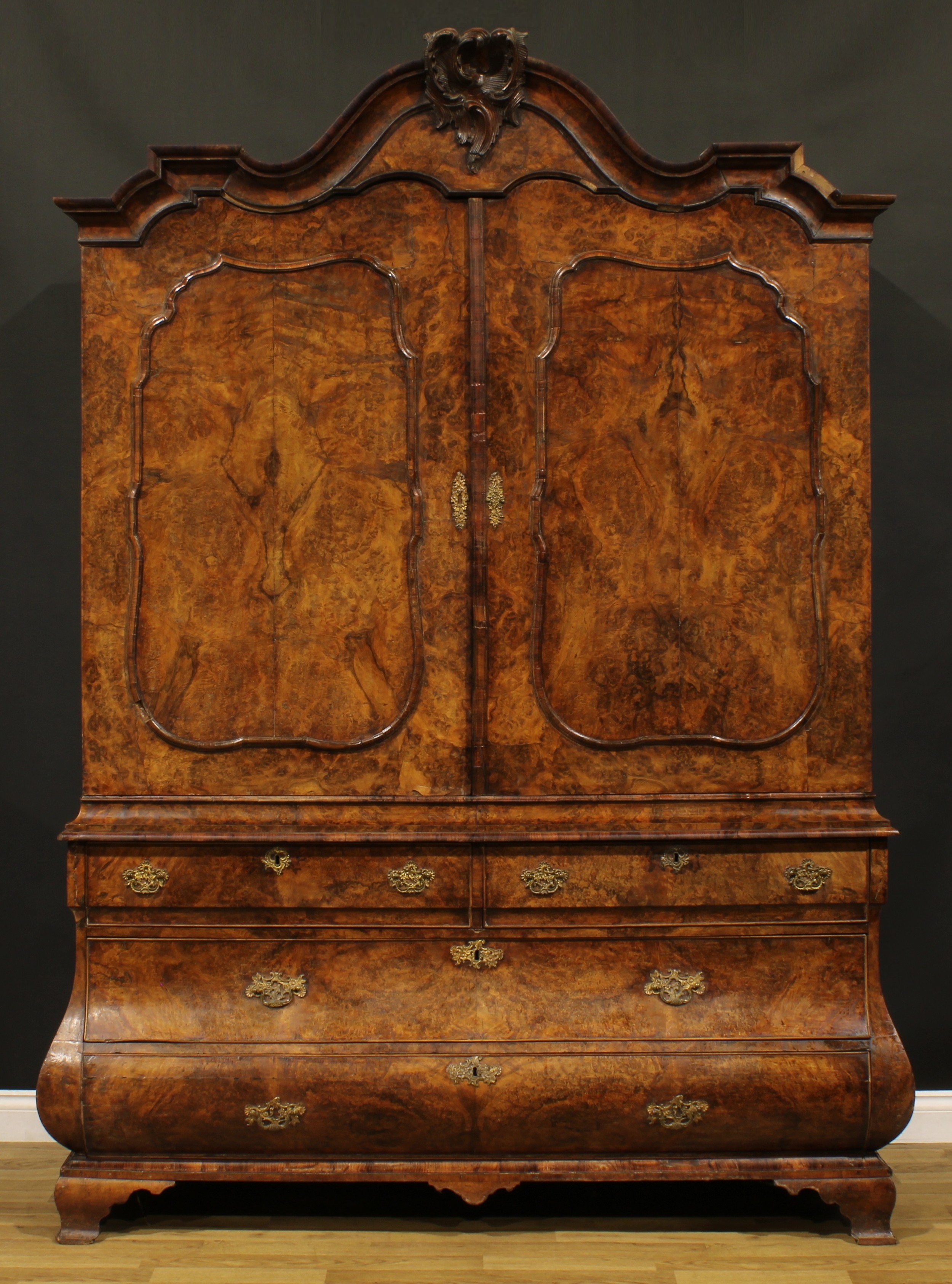 A large late 18th century Dutch burr walnut armoire or press cupboard, shaped chapeau de gendarme