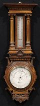 A late Victorian oak architectural wheel barometer, 15.5cm circular silvered register inscribed T.