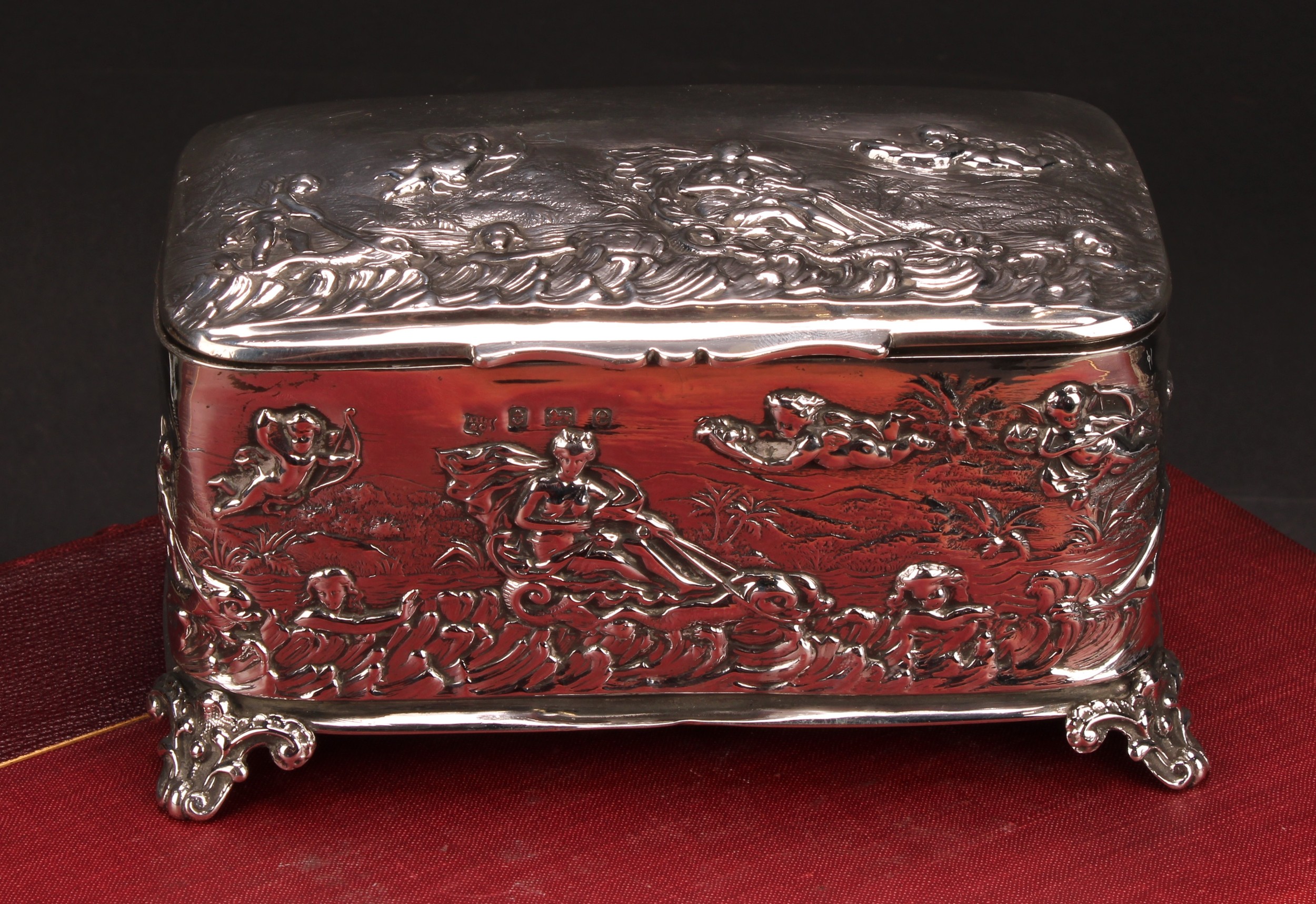 An Edwardian silver rounded rectangular casket, embossed after the antique with Venus in a chariot