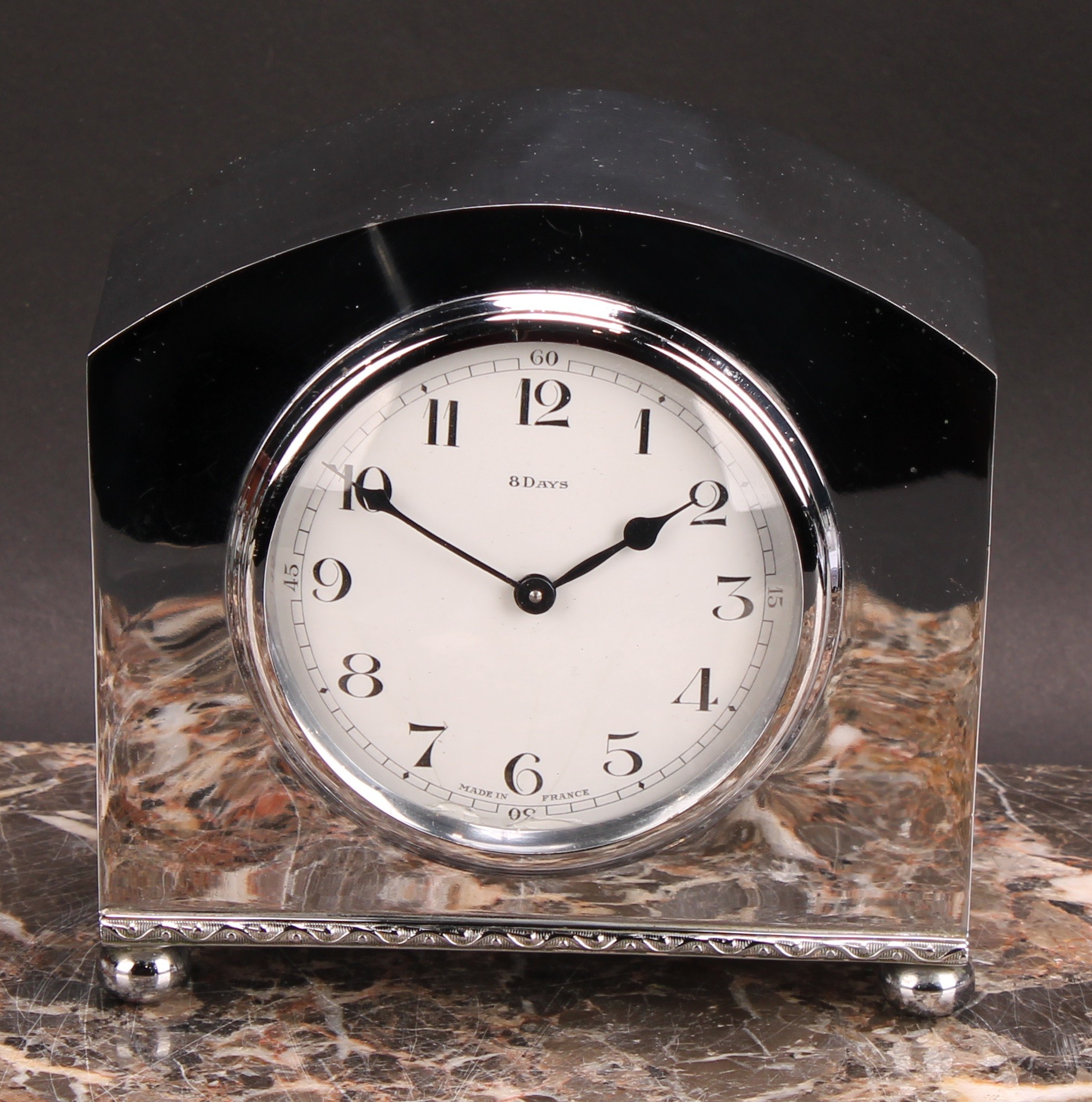 A mid 20th century French silver coloured metal mantel clock, 8cm circular enamel dial inscribed