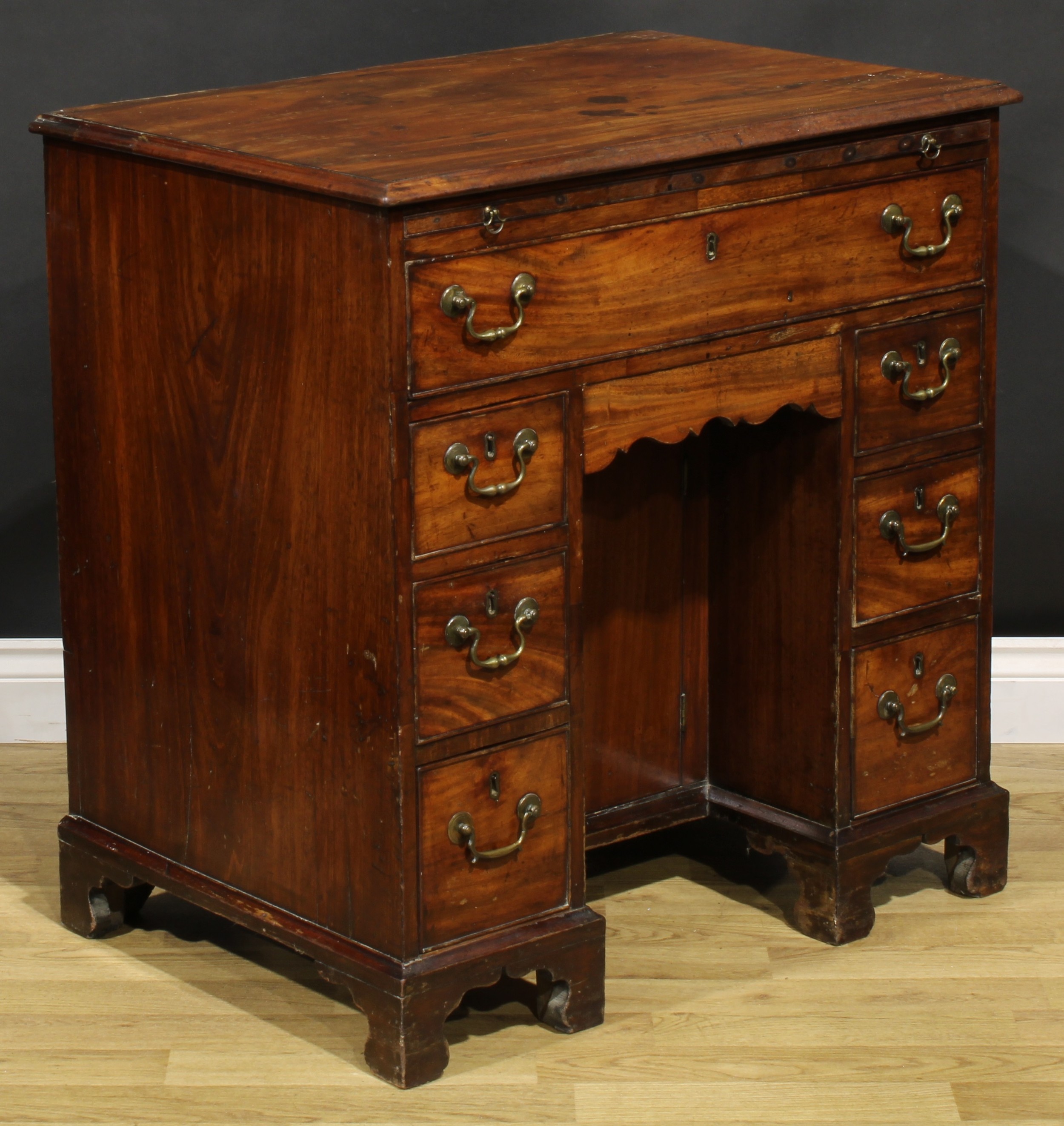 A George III mahogany kneehole desk, the ovolu moulded top above a brushing slide, axe head handles, - Image 5 of 8