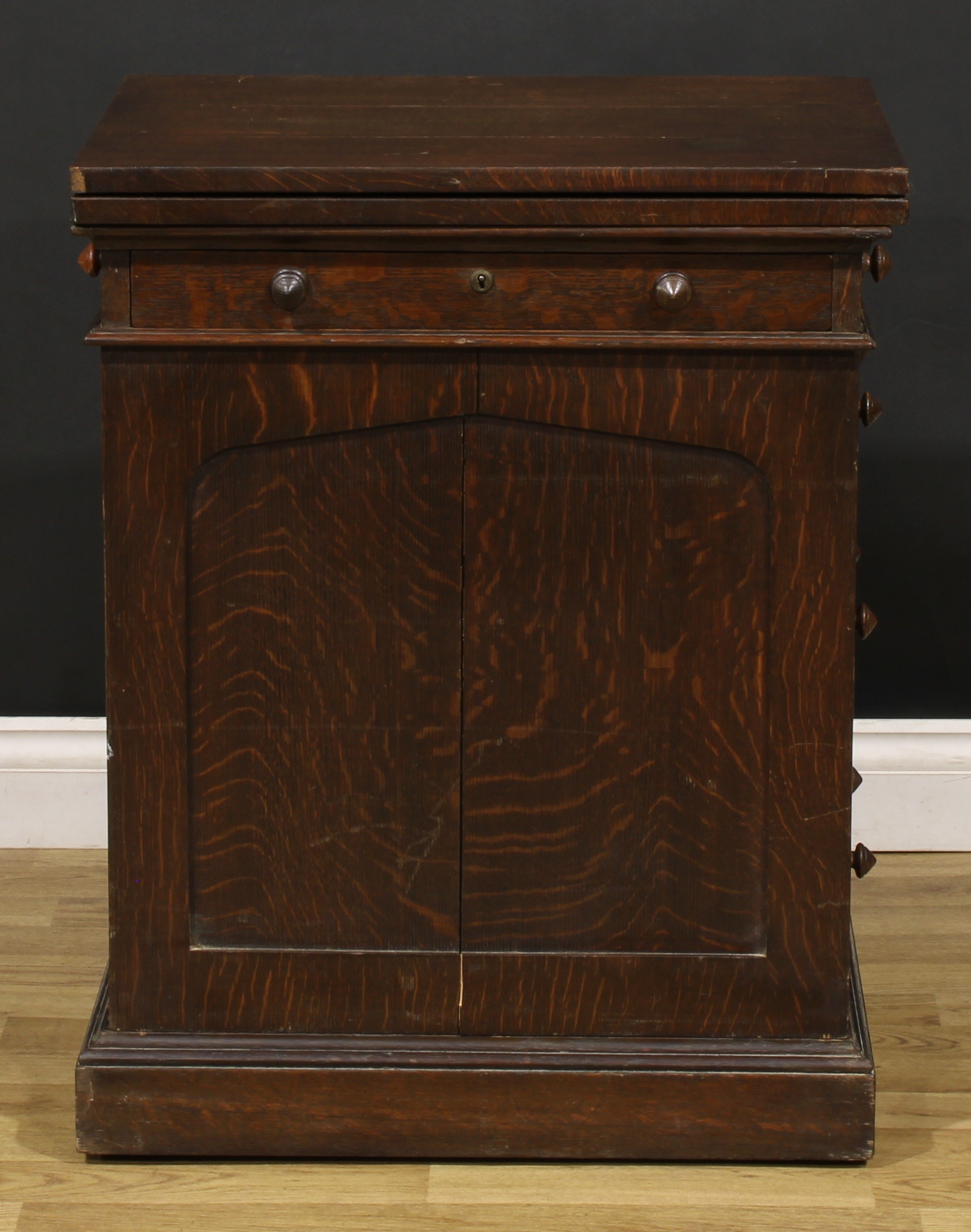 A late 19th century oak single pedestal desk, hinged top enclosing a baize surface above a long - Image 2 of 6