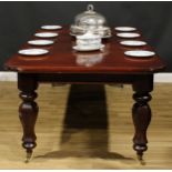 An early Victorian mahogany extending dining table, rounded rectangular top with moulded edge and