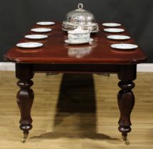 An early Victorian mahogany extending dining table, rounded rectangular top with moulded edge and