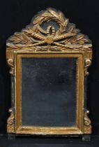 A Baroque parcel gilt and painted looking glass, rectangular plate, the shaped cresting centred by a