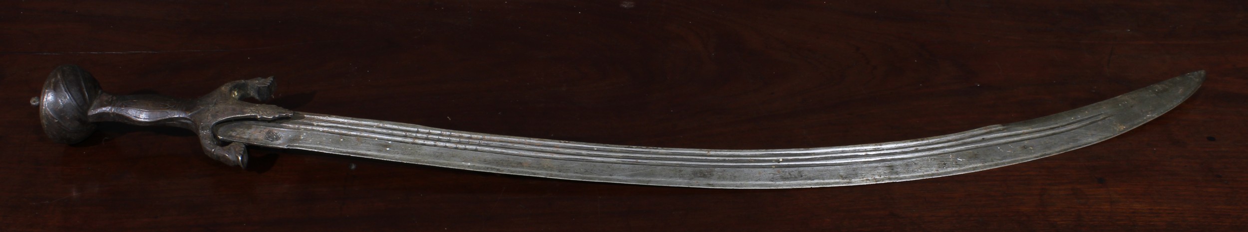 A 19th century Indian talwar, 72cm curved fullered blade with armourer’s mark, steel hilt with lotus - Image 2 of 3