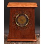 An Arts and Crafts oak mantel timepiece, 9cm circular dial decorated in mottled tones of orange