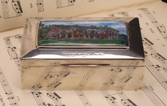 An Arts and Crafts silver and enamel rectangular box, hinged cover decorated with a named view of