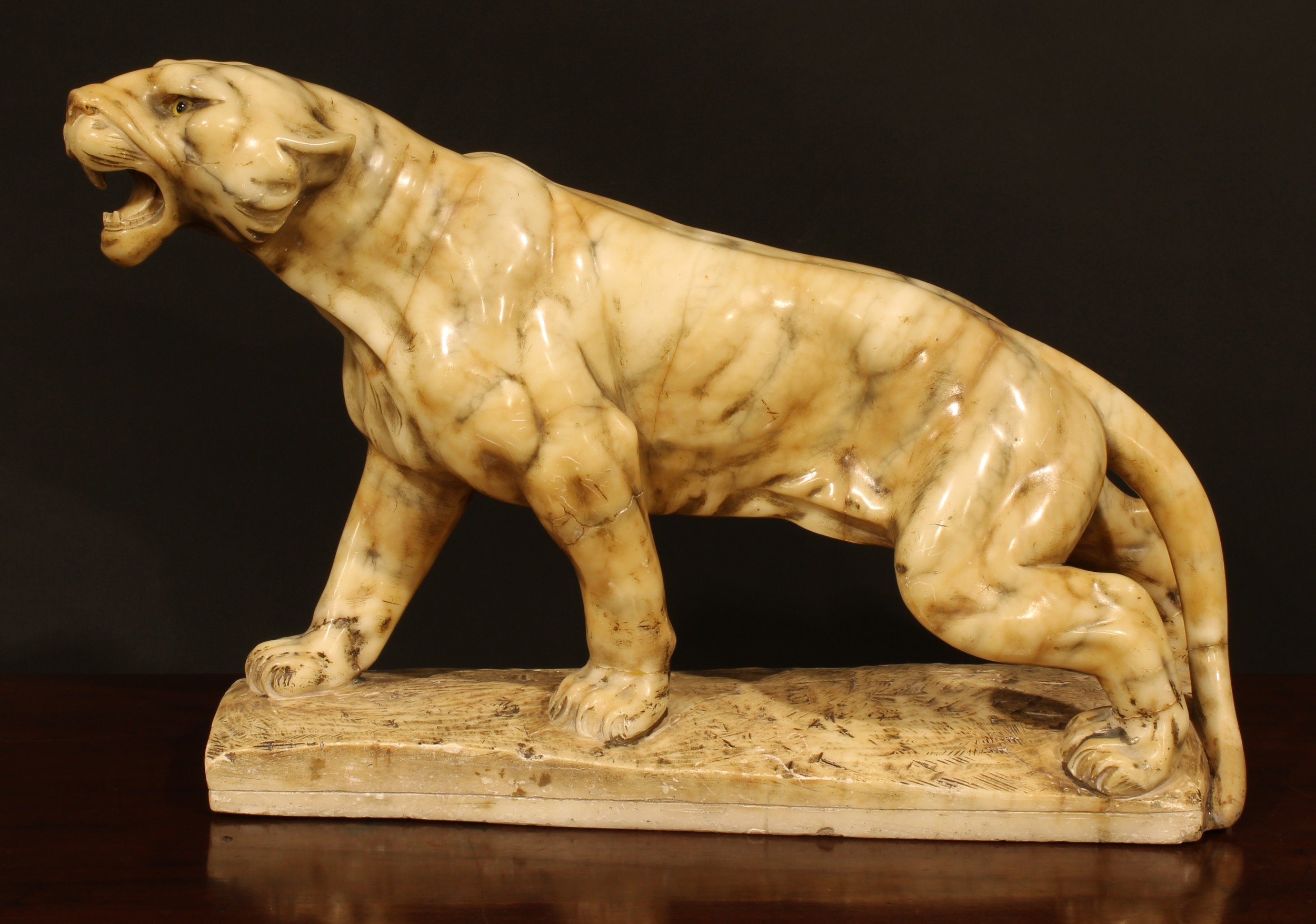 French School, first-half 20th century, an Art Deco alabaster model, of a tiger, 55cm wide
