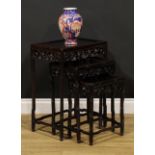 A Chinese hardwood harlequin nest of three occasional tables, each with a rectangular panel top,