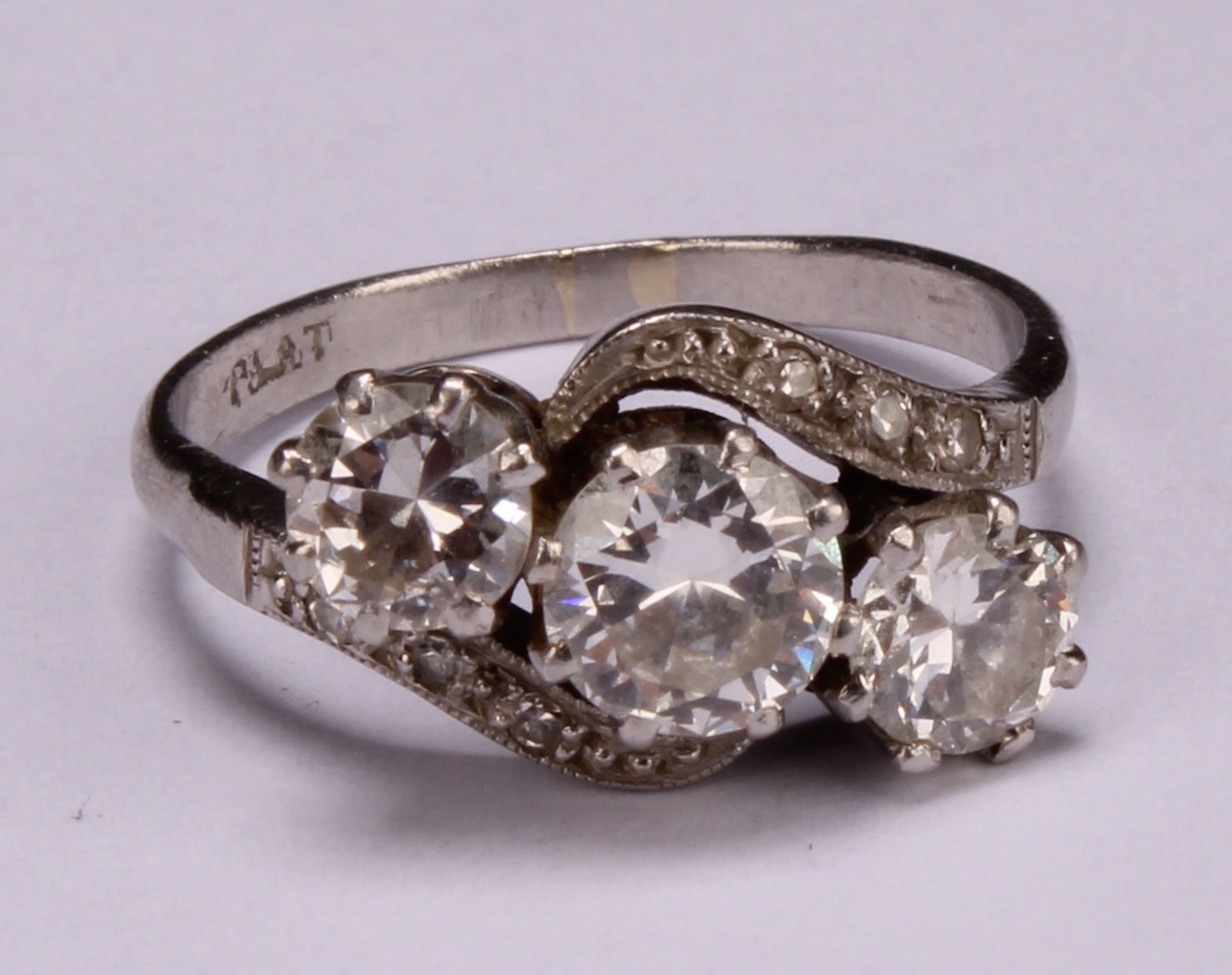 A diamond and platinum three stone twist ring, the central round brilliant cut stone flanked by - Image 4 of 4