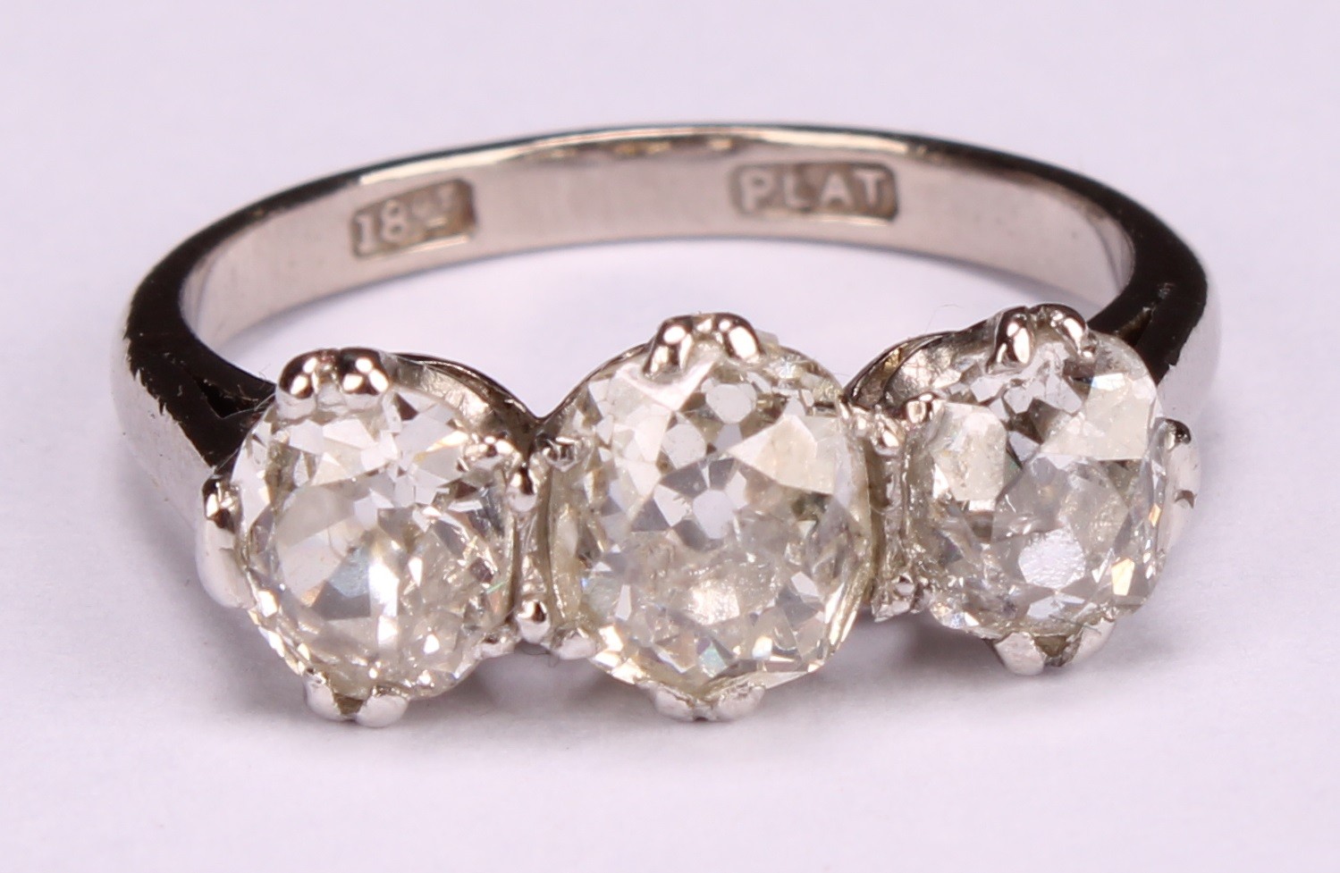 A diamond three stone ring, the central round brilliant cut stone flanked by two smaller stones, - Image 4 of 4