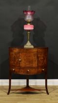 A Regency mahogany corner washstand, hinged splashback above a door and drawer, shaped undertier,