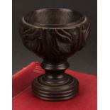 A 19th century oak goblet or chalice, the bowl carved with acanthus, turned base, 14cm high,