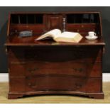 An unusual George III mahogany bureau, fall front enclosing a small door, small drawers, pigeonholes