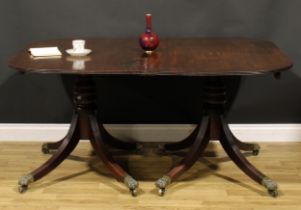 A Regency mahogany twin pillar dining table, rounded rectangular top with reeded edge, turned