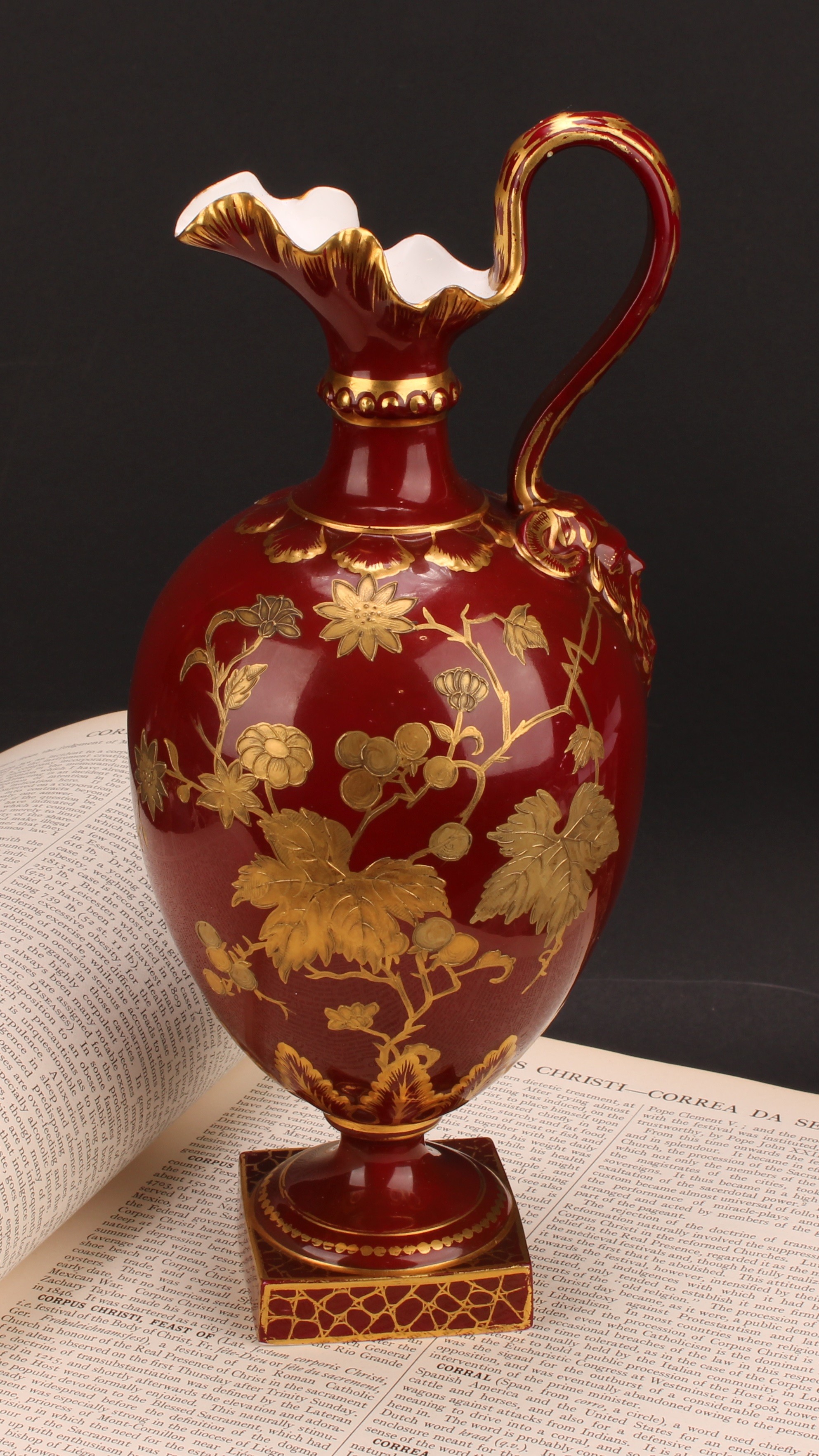 A Royal Crown Derby pedestal ewer, decorated in raised gilt with flowers, foliage and stiff leaves