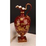 A Royal Crown Derby pedestal ewer, decorated in raised gilt with flowers, foliage and stiff leaves