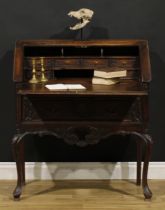 A French provincial Régence Revival oak bureau, fall front enclosing small drawers and