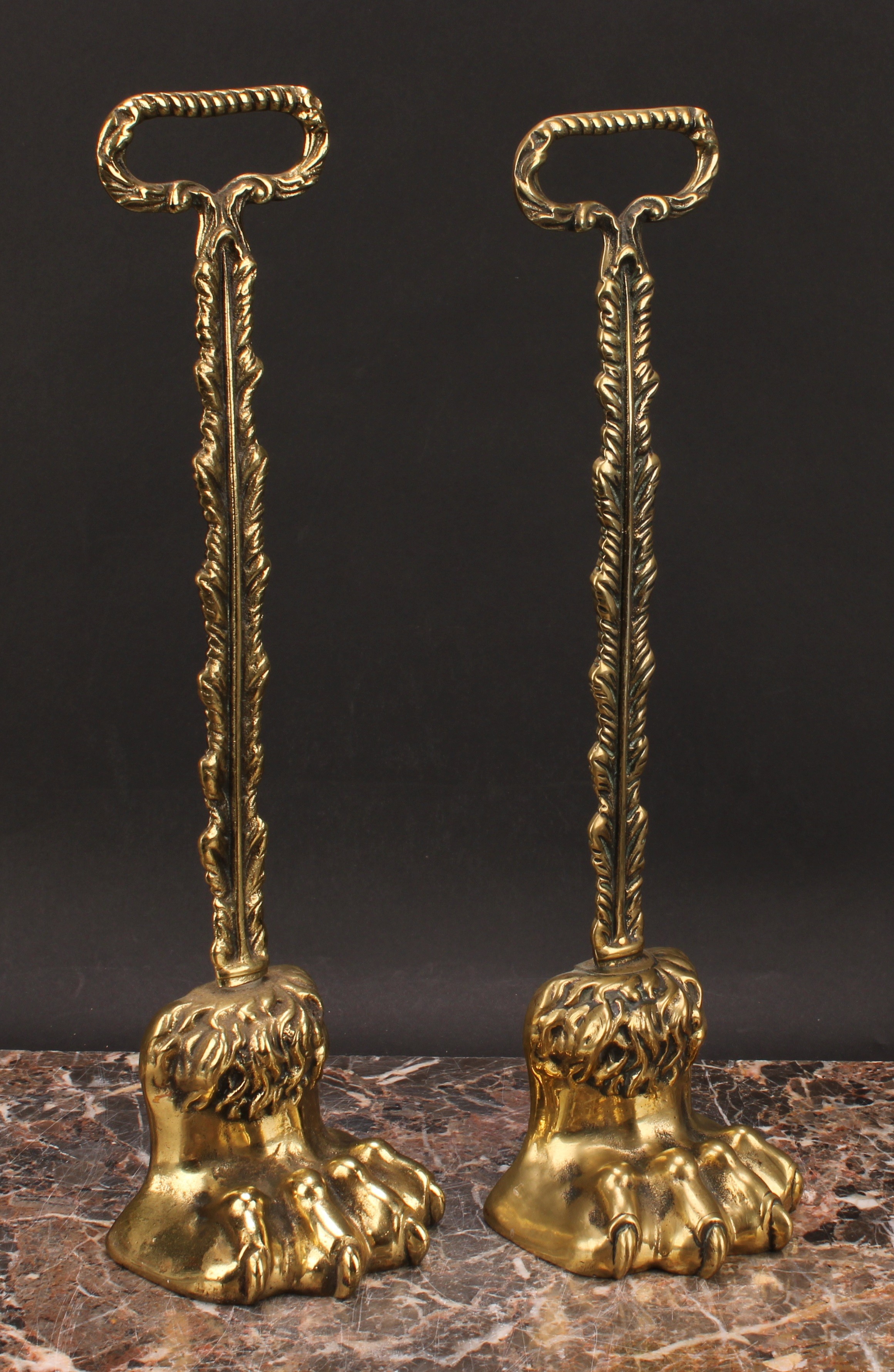 A pair of 19th century brass door stops, each cast as a lions paw, posted handles, lead-weighted - Image 3 of 3