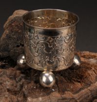 A Russian silver beaker, chased with scrolls, ball feet, 6cm high, 18th century