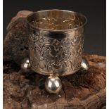 A Russian silver beaker, chased with scrolls, ball feet, 6cm high, 18th century