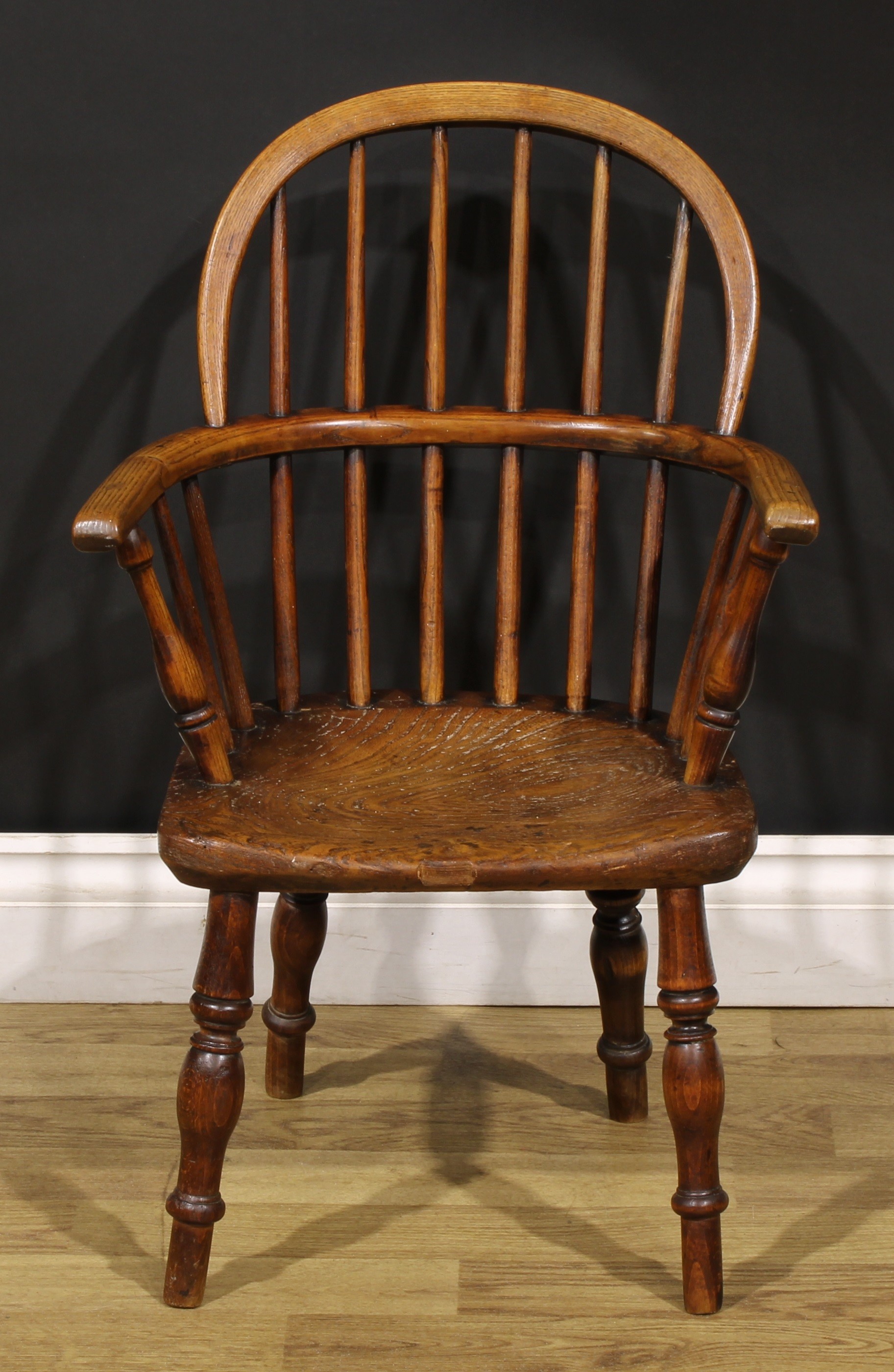 A 19th century ash and elm child’s Windsor elbow chair, 67cm high, 44cm wide