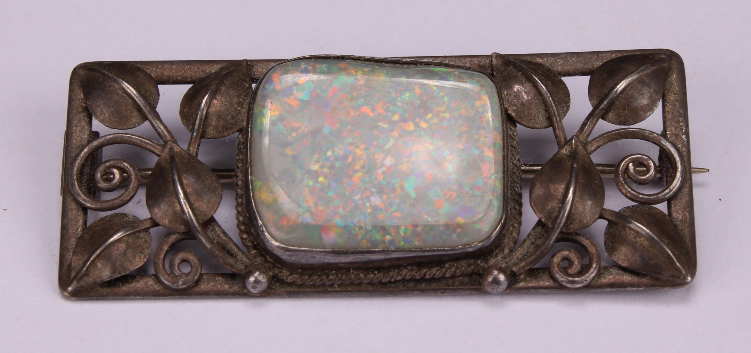 An Art & Crafts silver brooch, rectangular leafy pierced frame set with a single irregular - Image 2 of 3