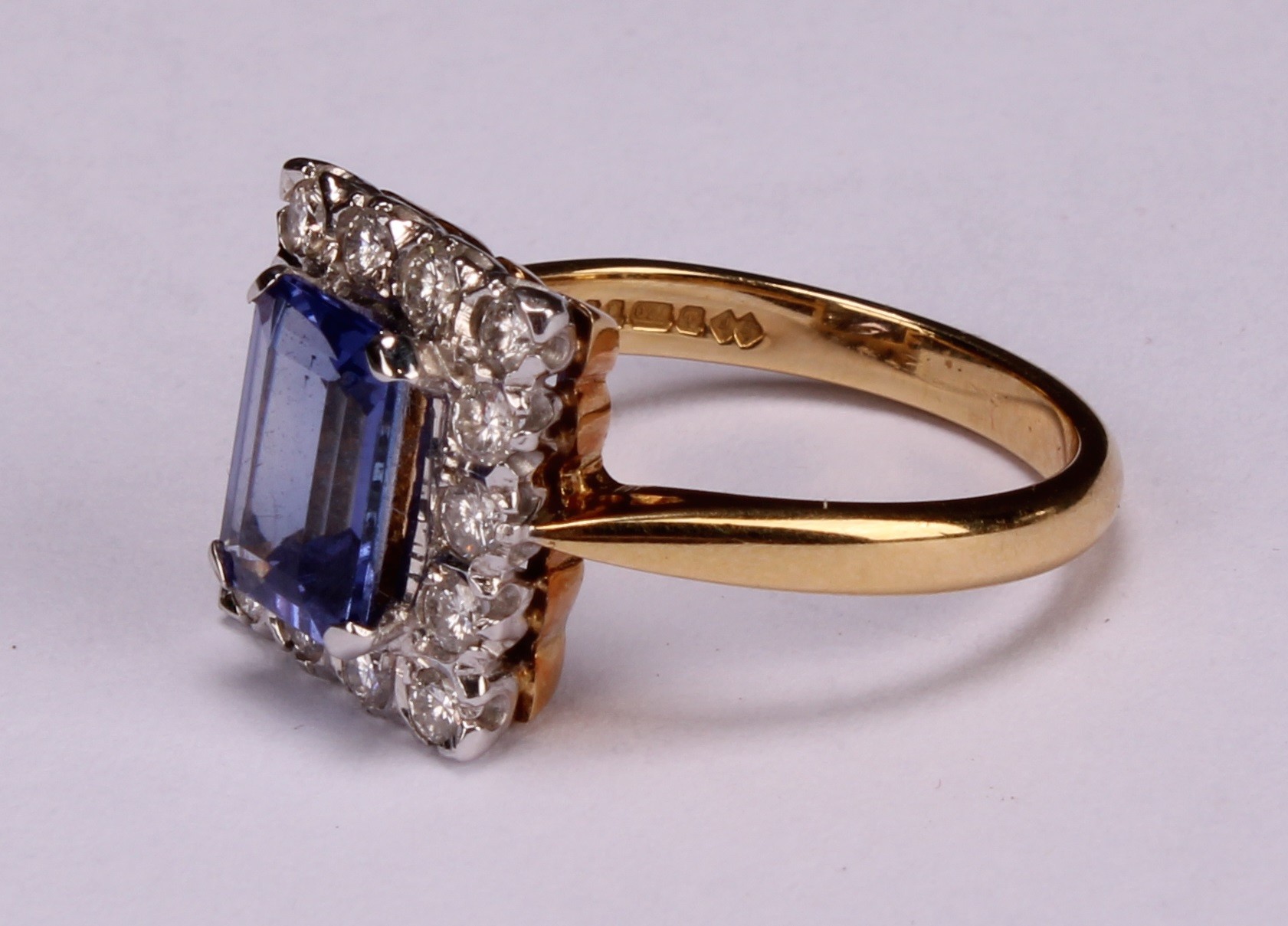 A tanzanite and diamond ring, the rectangular cushion cut stone claw set within a single band of - Image 3 of 5