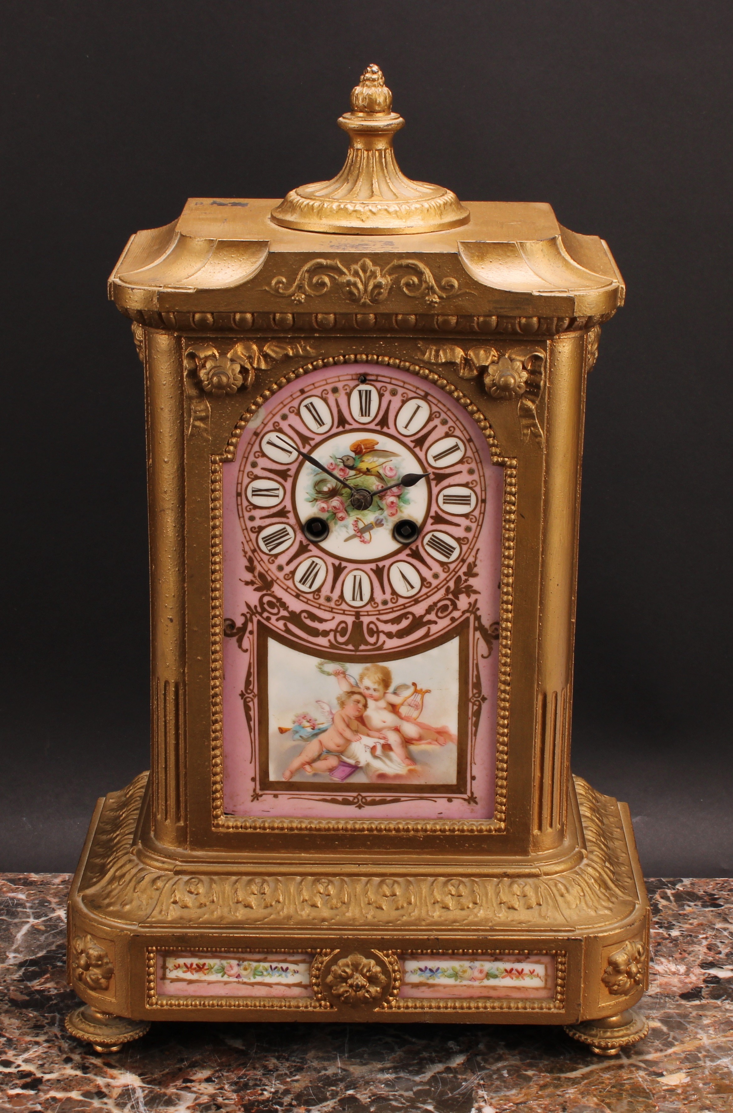 A late 19th century French spelter and porcelain mantel clock, the panel inscribed with Roman