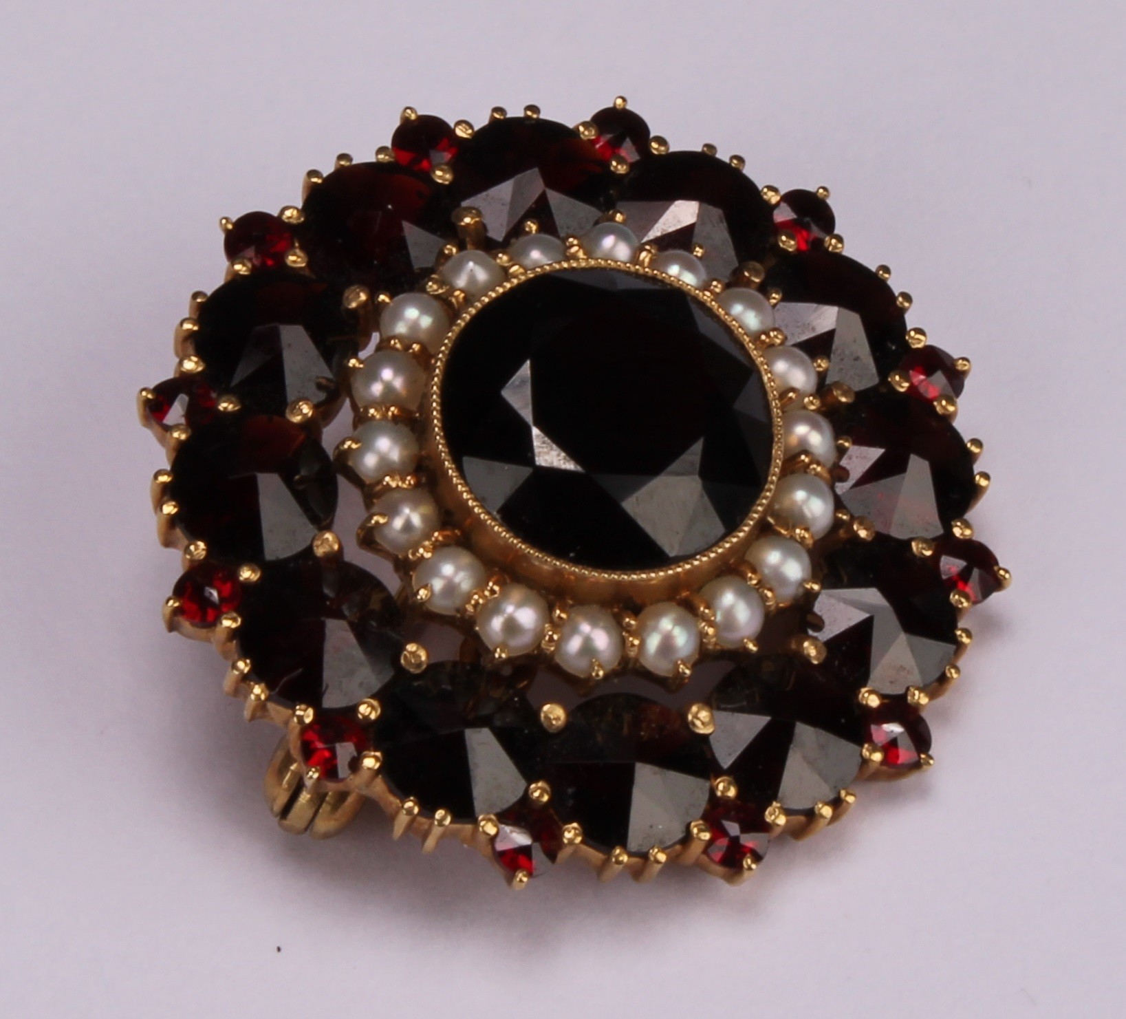 A Victorian style garnet and seed pearl target brooch, the large central round facet cut stone - Image 2 of 4