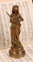 After Maurice Constant Favre (French, 1875-1919), a gilt bronze, Chant de la Fileuse, depicting a