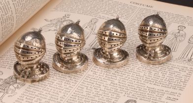 A set of four Victorian Gothic Revival silver novelty peppers, each as a knight's helmet and
