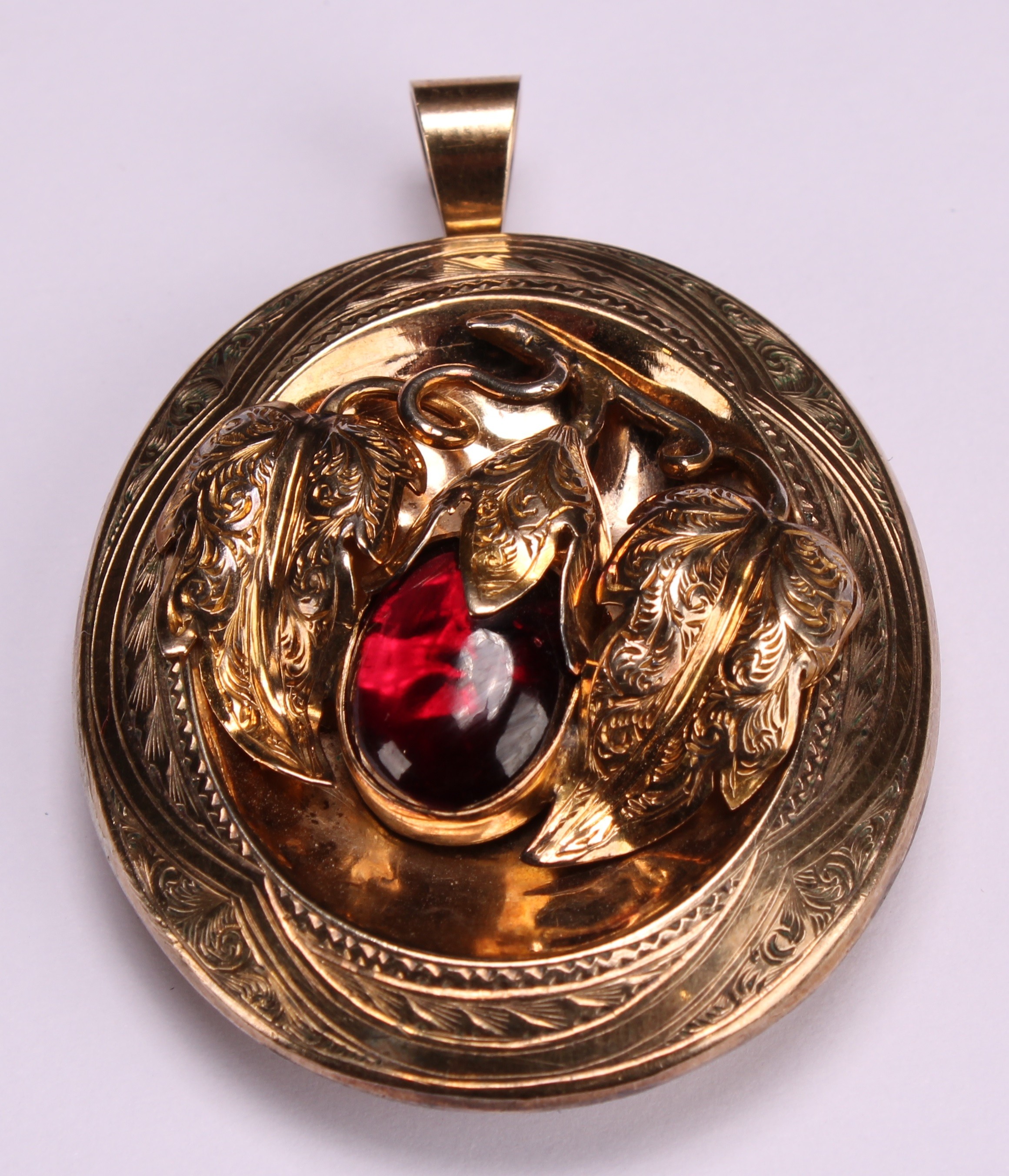 A Victorian gold coloured metal oval pendant, engraved with scrolls and centred by fruiting branches - Image 3 of 6