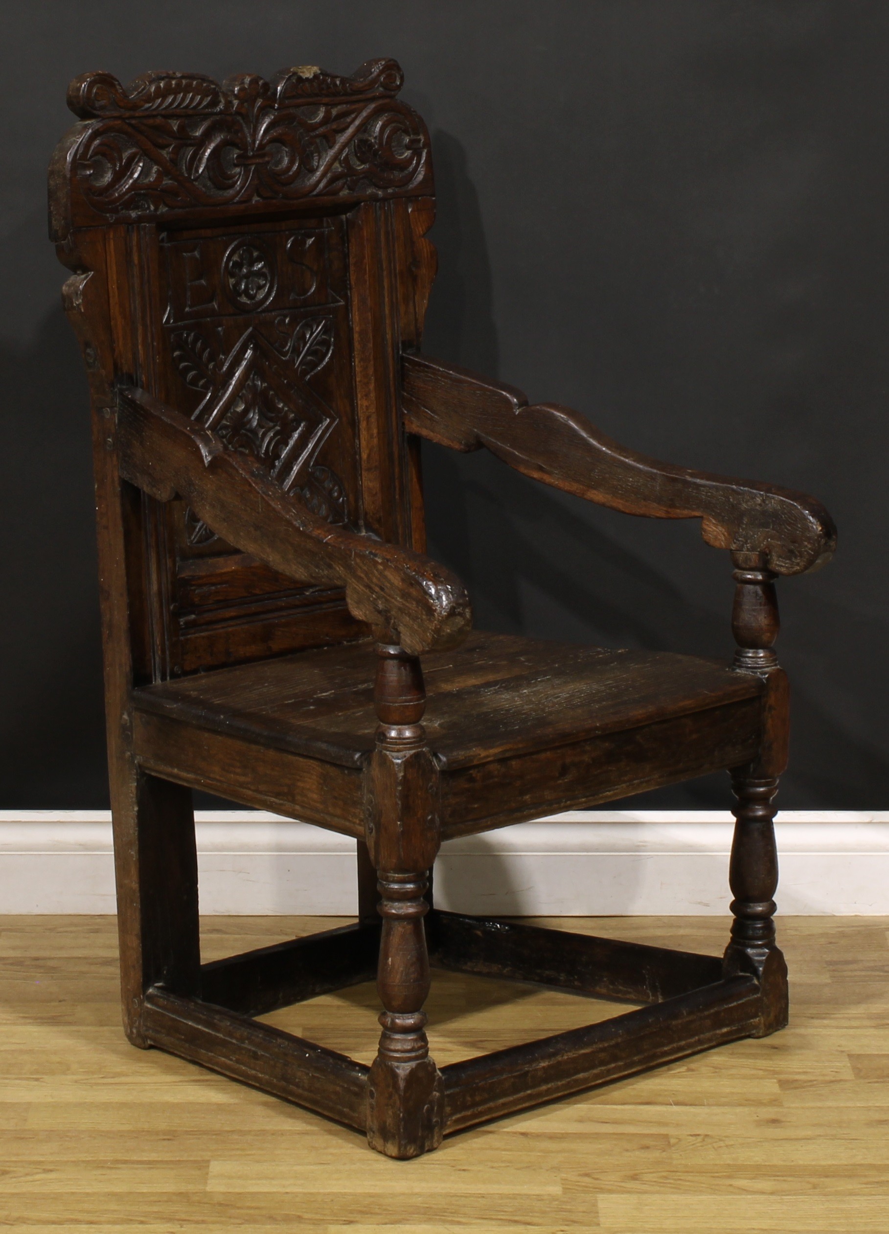 A 17th century oak wainscot armchair, shaped cresting carved with scrolling leafy branches, the - Image 2 of 4